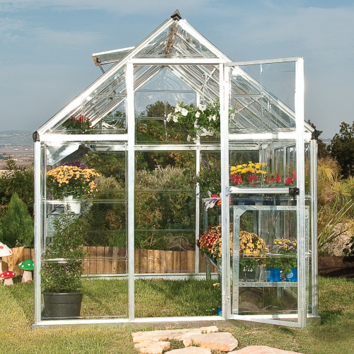 Greenhouse with open door showcasing the spacious interior filled with gardening tools and plants