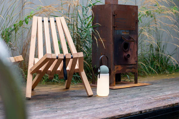 Weltevree Fieldchair set up in a backyard, showcasing its stylish and practical design.