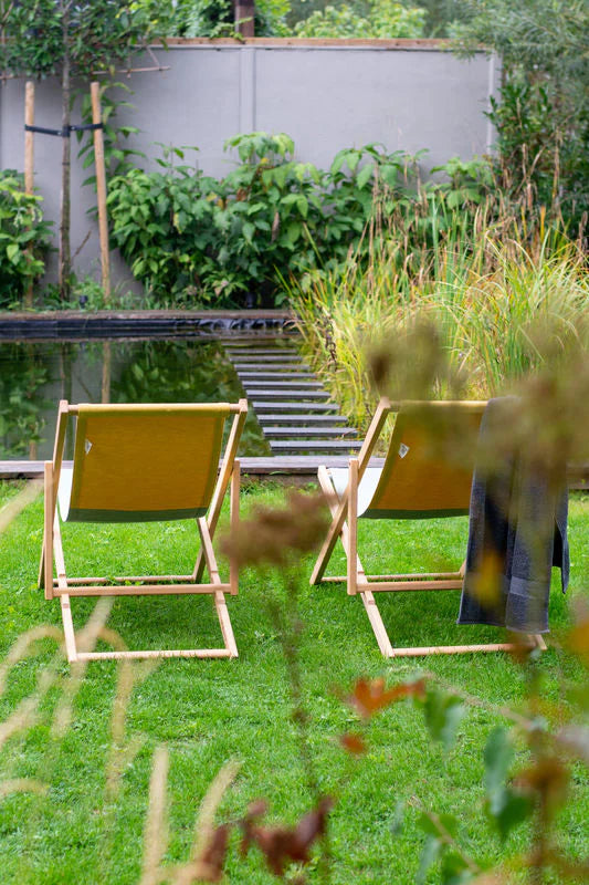 Two beach chairs on the patio by the pool at a house in Australia