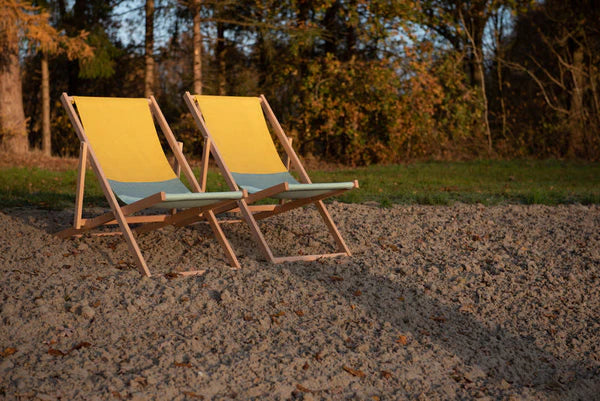 Two beach chairs in a serene natural setting at sunset in Australia